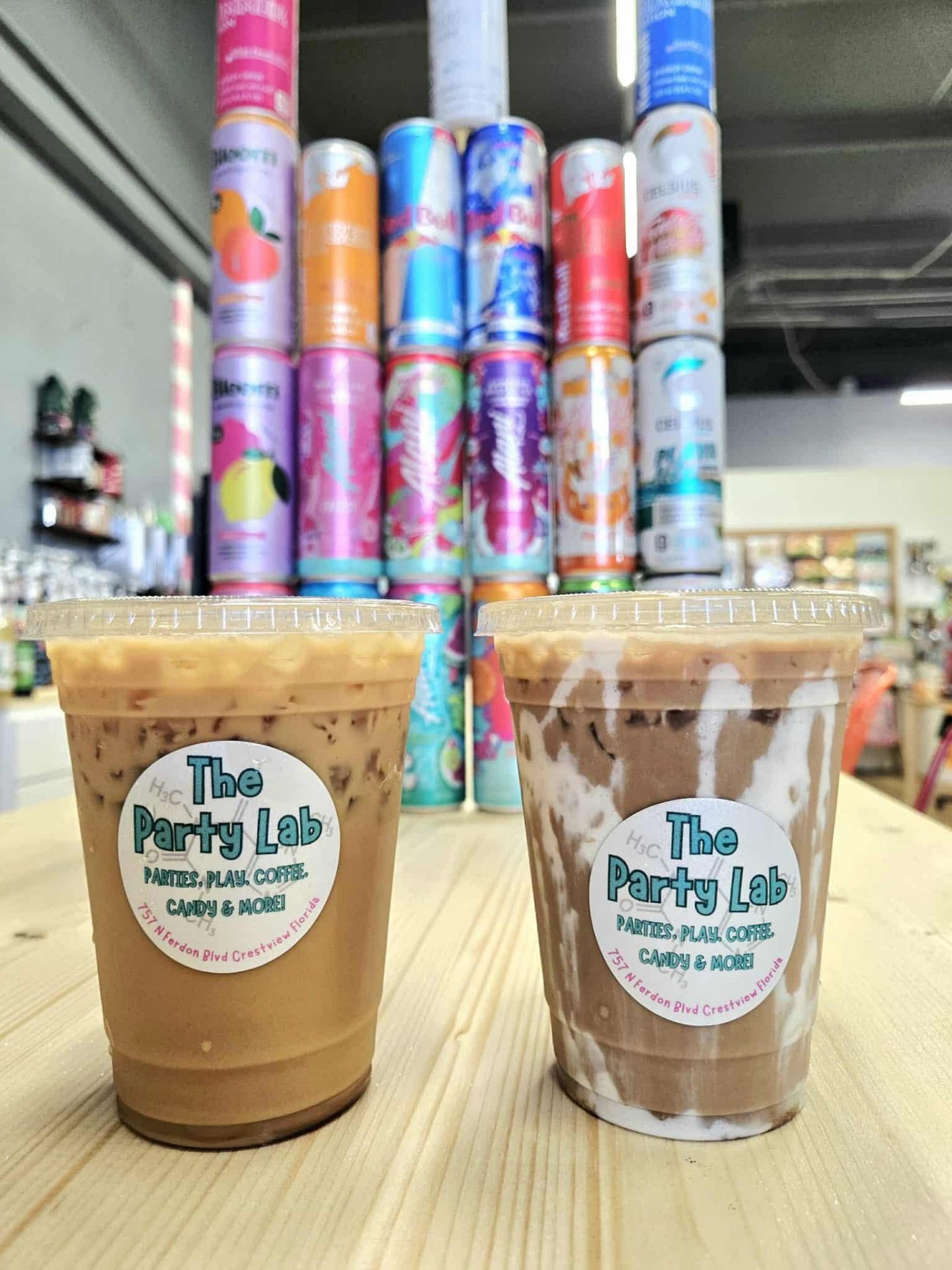 Energy drink cans stacked behind iced coffees
