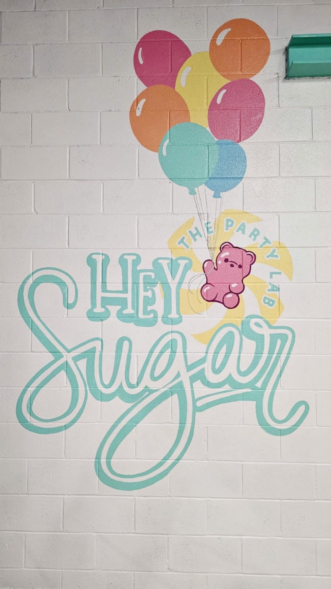 Hey Sugar mural with balloons and gummy bear