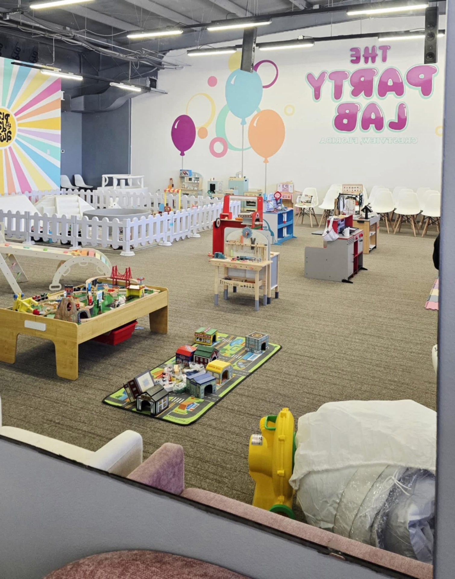Pretend-play kitchens, market and workbench area